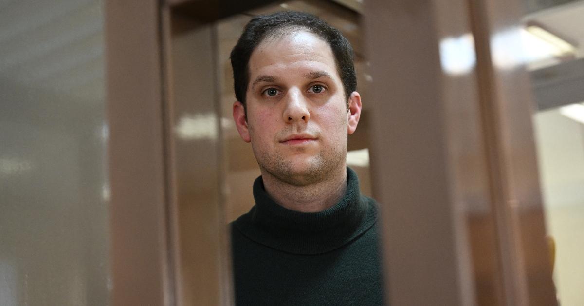 Evan Gershkovich, arrested on espionage charges, looks out from inside a defendants' cage before a hearing to consider an appeal on his extended pre-trial detention